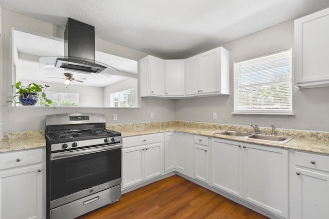 3221 Hage St, Houston, TX 77093 - kitchen featuring gas stove, island range hood, a sink, a ceiling fan, and light countertops