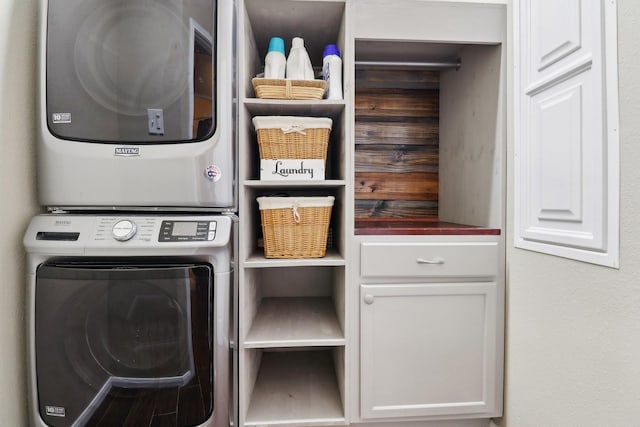 14039 Pawnee Bend Dr, Cypress, TX 77429 - laundry area with stacked washer and clothes dryer and cabinet space