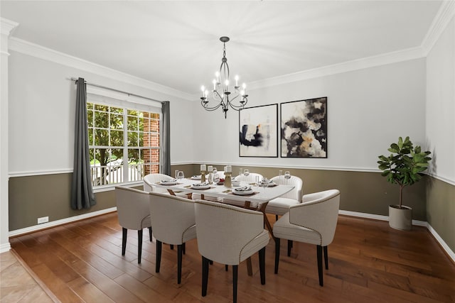 dining room with a chandelier, ornamental molding, wood finished floors, and baseboards