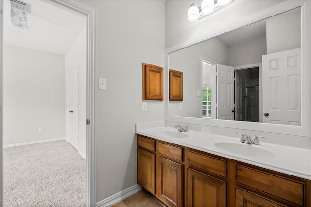 full bath with double vanity and baseboards