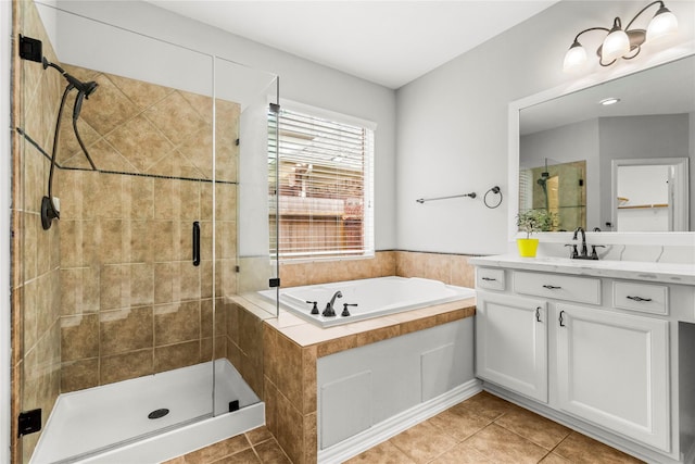 bathroom with a shower stall, a bath, vanity, and tile patterned floors