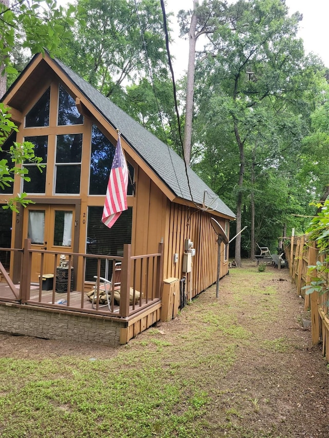 20 Shannon St, Huntsville, TX 77320 - view of side of property featuring roof with shingles, a patio, and board and batten siding