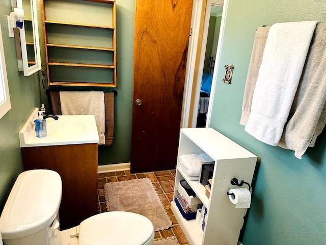 20 Shannon St, Huntsville, TX 77320 - bathroom featuring toilet, vanity, and baseboards