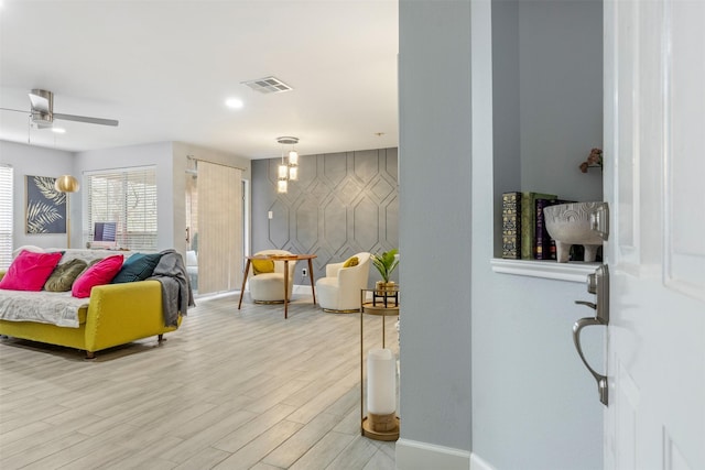 8051 Bay Branch Dr Unit 324, The Woodlands, TX 77382 - living room featuring light wood finished floors, baseboards, and a ceiling fan