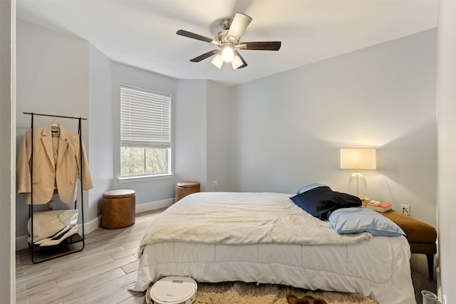 8051 Bay Branch Dr Unit 324, The Woodlands, TX 77382 - bedroom featuring wood finished floors, baseboards, and a ceiling fan