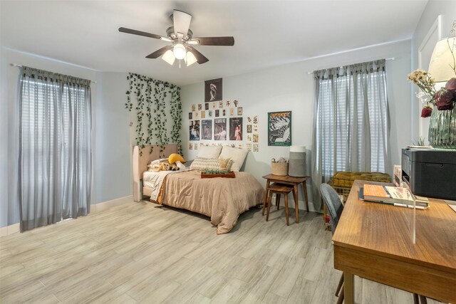 8051 Bay Branch Dr Unit 324, The Woodlands, TX 77382 - bedroom with wood finished floors, baseboards, and a ceiling fan