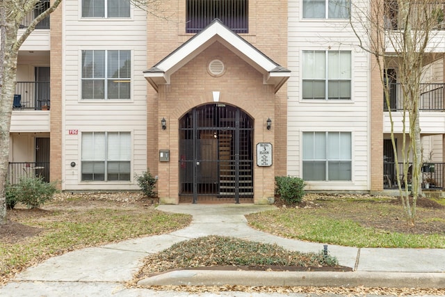 8051 Bay Branch Dr Unit 324, The Woodlands, TX 77382 - view of exterior entry with brick siding