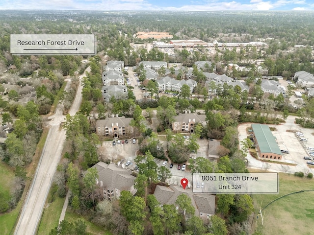 8051 Bay Branch Dr Unit 324, The Woodlands, TX 77382 - aerial overview of property's location featuring nearby suburban area and a heavily wooded area