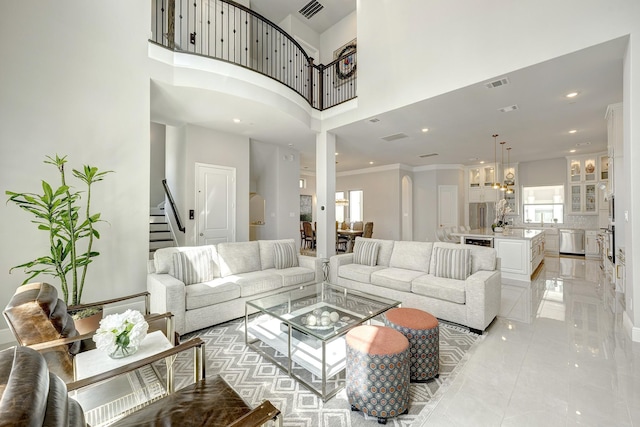 3604 Dorset Cliff Ln, Houston, TX 77055 - living room with stairway, a high ceiling, recessed lighting, crown molding, and a chandelier