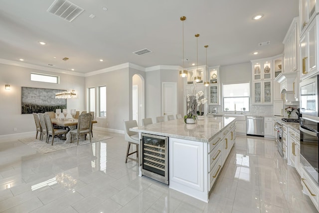 3604 Dorset Cliff Ln, Houston, TX 77055 - kitchen featuring appliances with stainless steel finishes, beverage cooler, white cabinets, recessed lighting, and baseboards