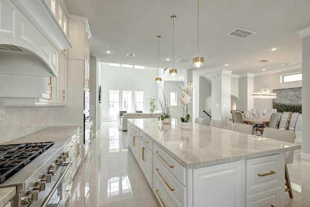 3604 Dorset Cliff Ln, Houston, TX 77055 - kitchen featuring open floor plan, white cabinets, decorative backsplash, recessed lighting, and light stone countertops