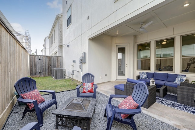 3604 Dorset Cliff Ln, Houston, TX 77055 - fenced backyard with an outdoor living space with a fire pit, cooling unit, a patio, and ceiling fan