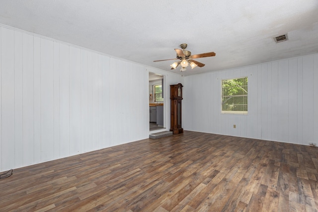 126 Cris Rd, Lufkin, TX 75901 - unfurnished living room featuring wood finished floors, ceiling fan, and wood walls