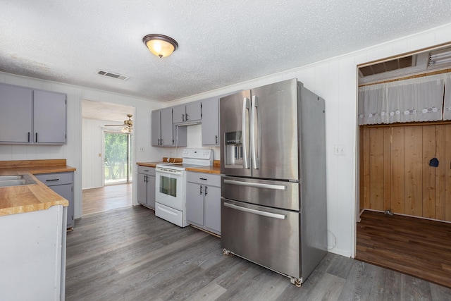 126 Cris Rd, Lufkin, TX 75901 - kitchen with stainless steel fridge, electric stove, gray cabinetry, wood counters, and a textured ceiling