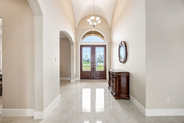 2119 Red Bird Ln, Brookshire, TX 77423 - foyer featuring arched walkways, light marble finish flooring, a chandelier, and baseboards
