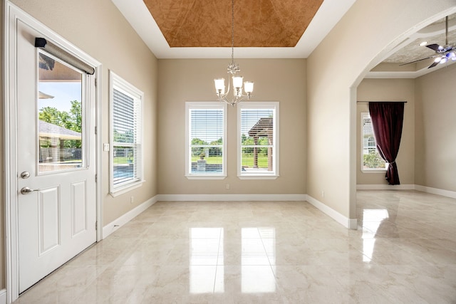 2119 Red Bird Ln, Brookshire, TX 77423 - unfurnished dining area with a chandelier, ceiling fan, arched walkways, a tray ceiling, and light marble finish flooring