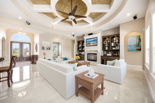 2119 Red Bird Ln, Brookshire, TX 77423 - living area with coffered ceiling, recessed lighting, a ceiling fan, a glass covered fireplace, and french doors