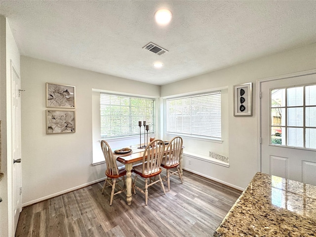 9630 E Withers Way Cir, Houston, TX 77065 - dining room with wood finished floors, a textured ceiling, and baseboards