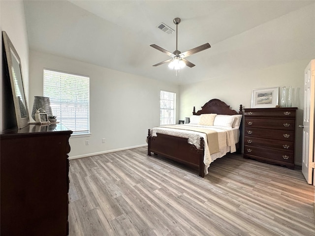 9630 E Withers Way Cir, Houston, TX 77065 - bedroom with light wood-style floors, baseboards, vaulted ceiling, and a ceiling fan