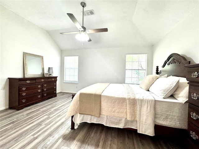 9630 E Withers Way Cir, Houston, TX 77065 - bedroom with vaulted ceiling, multiple windows, wood finished floors, baseboards, and a ceiling fan