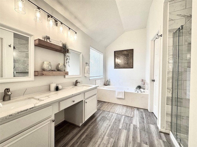 9630 E Withers Way Cir, Houston, TX 77065 - bathroom featuring vaulted ceiling, wood finished floors, a stall shower, double vanity, and a bath