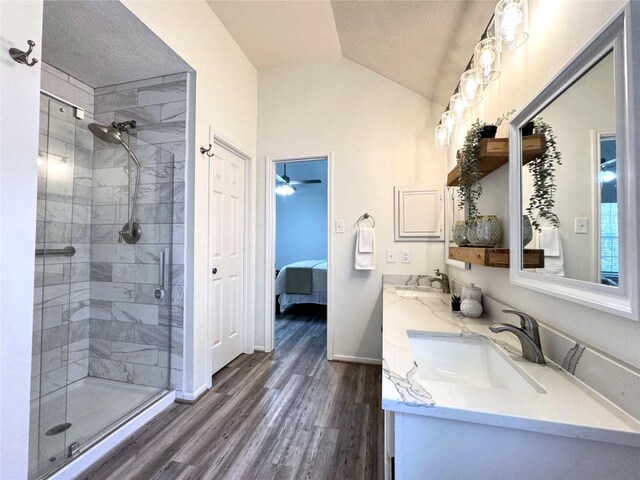 9630 E Withers Way Cir, Houston, TX 77065 - ensuite bathroom with wood finished floors, a shower stall, vaulted ceiling, baseboards, and double vanity