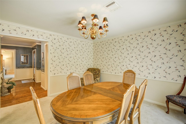 5410 Coral Ridge Rd, Houston, TX 77069 - dining space featuring wallpapered walls, a chandelier, a wainscoted wall, ornamental molding, and light carpet