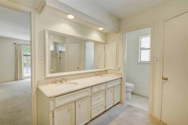 5410 Coral Ridge Rd, Houston, TX 77069 - bathroom with toilet, double vanity, and baseboards