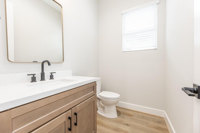 3312 Bremond St, Houston, TX 77004 - bathroom with wood finished floors, vanity, toilet, and baseboards