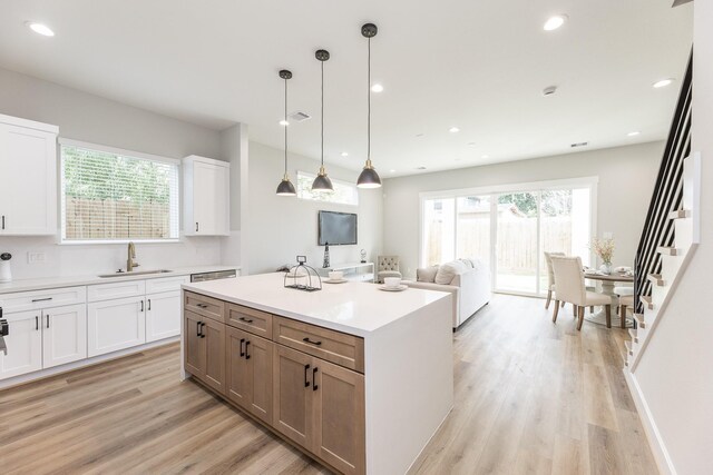 3312 Bremond St, Houston, TX 77004 - kitchen with a sink, light wood-type flooring, white cabinets, healthy amount of natural light, and recessed lighting
