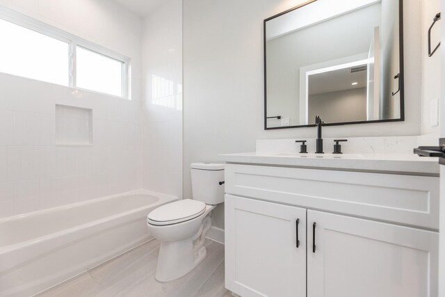 3312 Bremond St, Houston, TX 77004 - bathroom with toilet, vanity,  shower combination, and wood finished floors