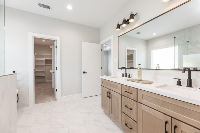 3312 Bremond St, Houston, TX 77004 - full bathroom with a shower stall, a spacious closet, double vanity, marble look tile flooring, and recessed lighting