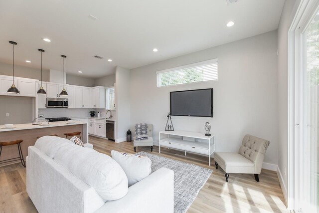 3312 Bremond St, Houston, TX 77004 - living area featuring recessed lighting, light wood finished floors, and baseboards