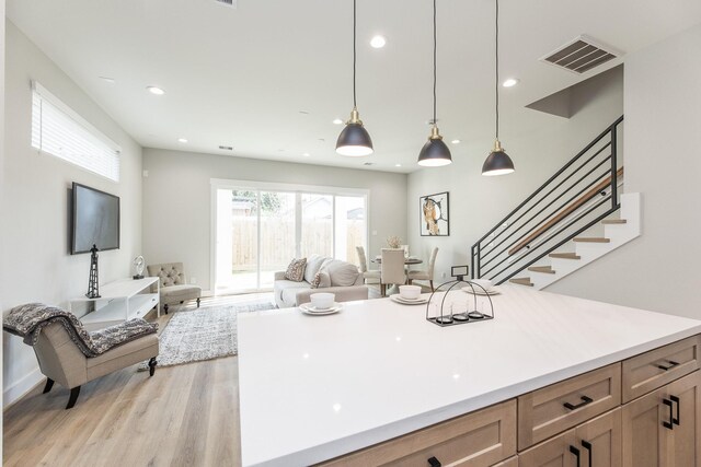 3312 Bremond St, Houston, TX 77004 - kitchen with light wood-type flooring, open floor plan, light countertops, decorative light fixtures, and recessed lighting