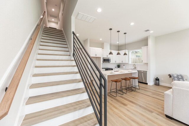 3312 Bremond St, Houston, TX 77004 - stairs featuring wood finished floors, recessed lighting, and baseboards
