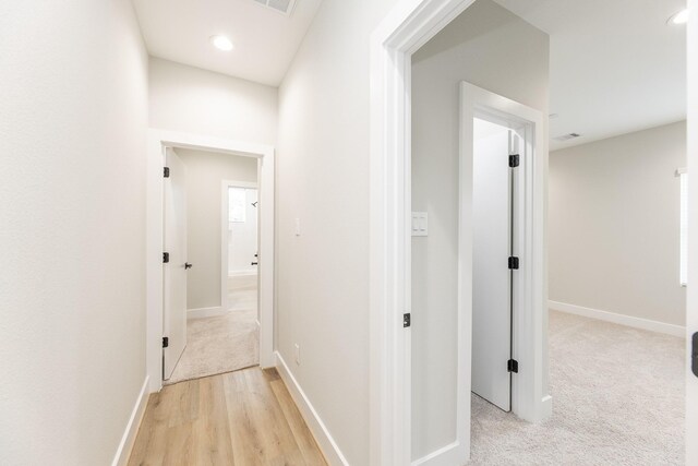 3312 Bremond St, Houston, TX 77004 - hall with baseboards, recessed lighting, light colored carpet, and light wood finished floors