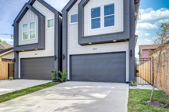 3312 Bremond St, Houston, TX 77004 - view of front of home with board and batten siding, an attached garage, and fence