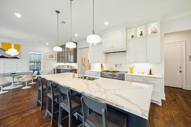 712 E 14th St, Houston, TX 77008 - kitchen with a sink, double oven range, backsplash, a kitchen island with sink, and dark wood finished floors