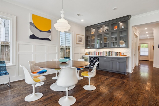 712 E 14th St, Houston, TX 77008 - dining space featuring a decorative wall, ornamental molding, dark wood-type flooring, and recessed lighting