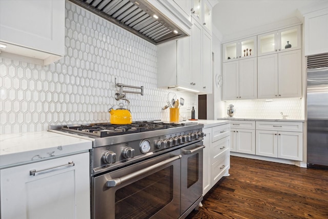 712 E 14th St, Houston, TX 77008 - kitchen with high quality appliances, custom exhaust hood, tasteful backsplash, glass insert cabinets, and white cabinetry