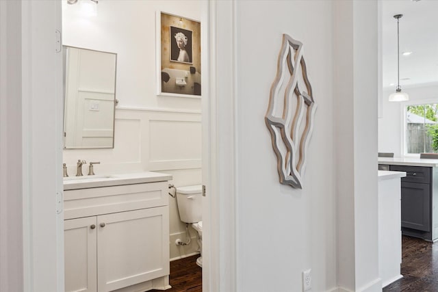 712 E 14th St, Houston, TX 77008 - bathroom featuring a decorative wall, wood finished floors, vanity, and toilet