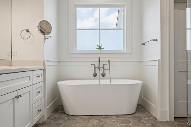 712 E 14th St, Houston, TX 77008 - bathroom with a decorative wall, a wainscoted wall, vanity, and a soaking tub