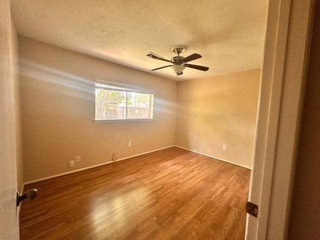 959 Reseda Dr, Houston, TX 77062 - unfurnished room featuring wood finished floors, a ceiling fan, baseboards, and a textured ceiling