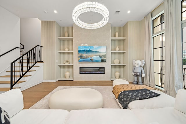 5820 Winsome Ln Unit B, Houston, TX 77057 - living room featuring built in shelves, wood finished floors, baseboards, stairway, and a large fireplace