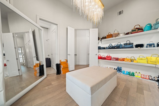 5820 Winsome Ln Unit B, Houston, TX 77057 - bedroom featuring light wood-style flooring, a chandelier, and a high ceiling