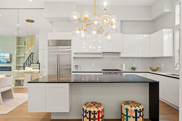 5820 Winsome Ln Unit B, Houston, TX 77057 - kitchen featuring built in refrigerator, white cabinetry, light wood finished floors, and range