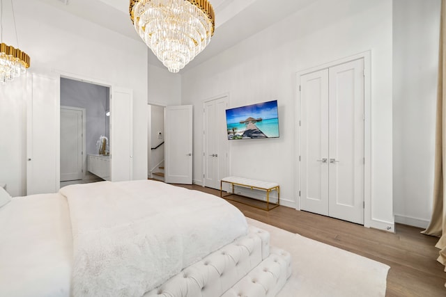 5820 Winsome Ln Unit B, Houston, TX 77057 - bedroom with a chandelier, two closets, wood finished floors, and baseboards