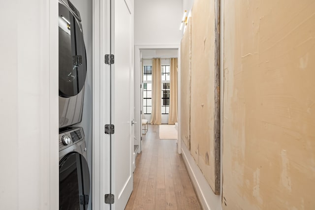 5820 Winsome Ln Unit B, Houston, TX 77057 - laundry area with stacked washer and clothes dryer, light wood finished floors, and baseboards