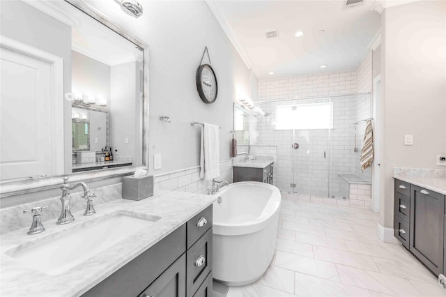 2110 Mason St, Houston, TX 77006 - full bath with a stall shower, two vanities, a soaking tub, recessed lighting, and crown molding