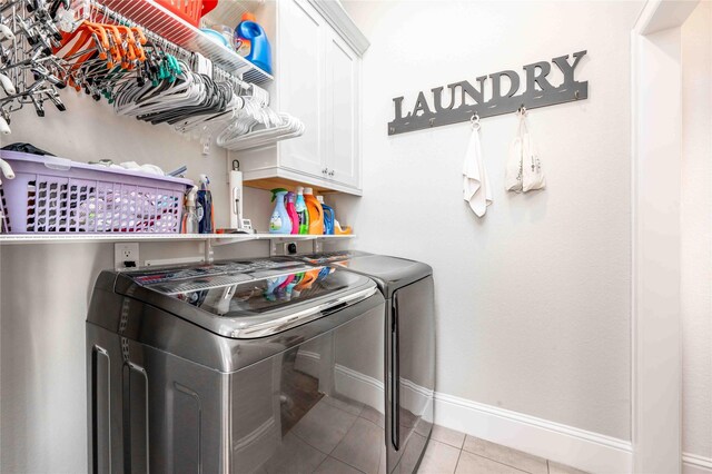 2110 Mason St, Houston, TX 77006 - laundry area with independent washer and dryer, cabinet space, tile patterned floors, and baseboards